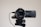 A high-definition Sony 4K Handycam mounted on a tripod, with the lens facing forward. The camcorder features a Zeiss lens and is connected by a cable. It appears clean and ready for use, with details of its specifications visible on the camera body.