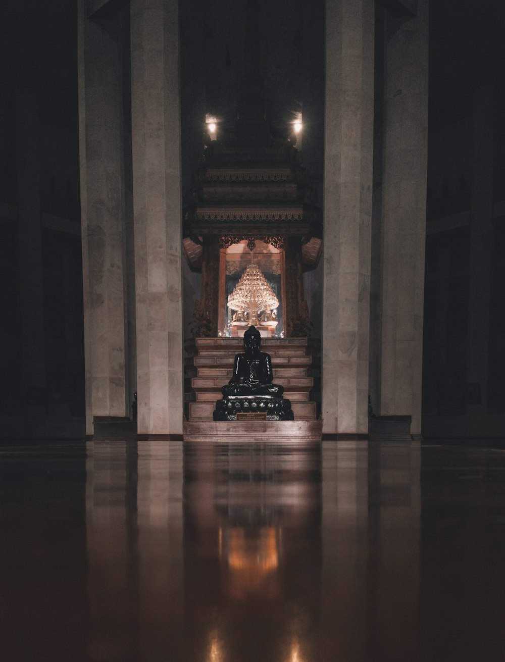 a person sitting on a bench in a dimly lit room