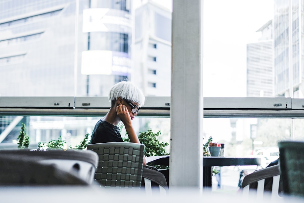 man sitting on chair in front of table