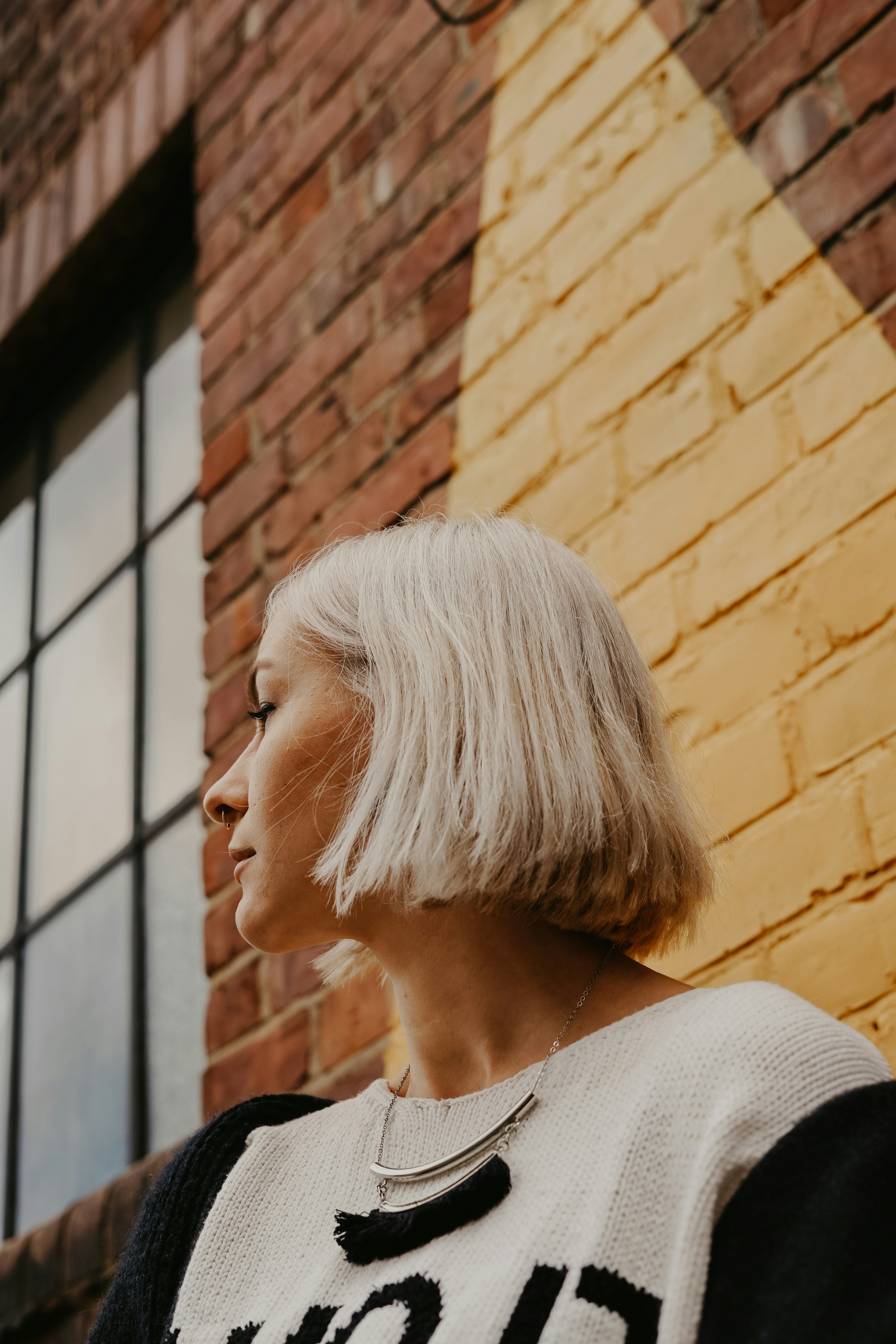 woman near building wearing white blouse