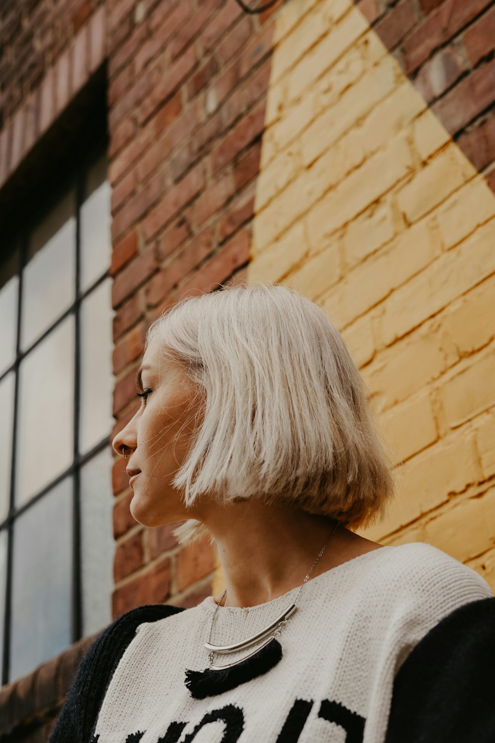 woman near building wearing white blouse