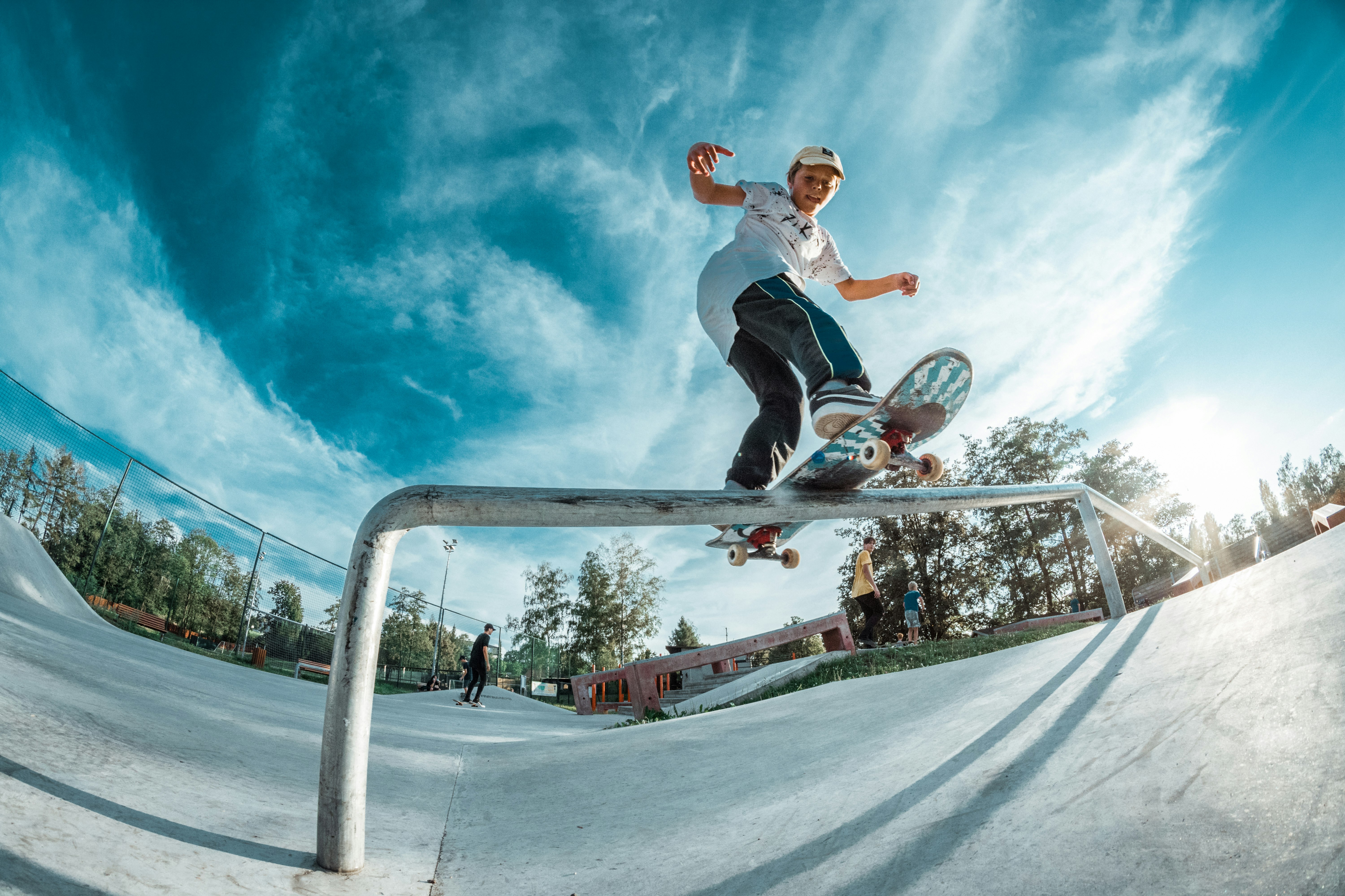 man riding skateboard doing grind rail during daytime