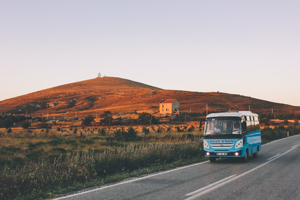 blue bus on road during daytime