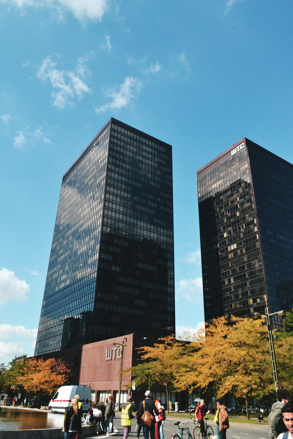 low angle photography of two black curtain high-glass buildings during daytime