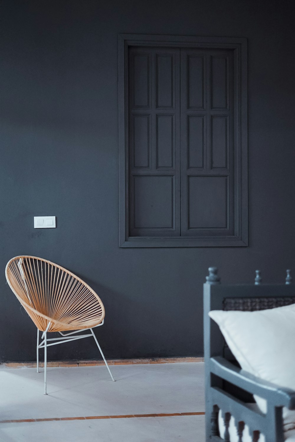 orange and white metal chair next to wall