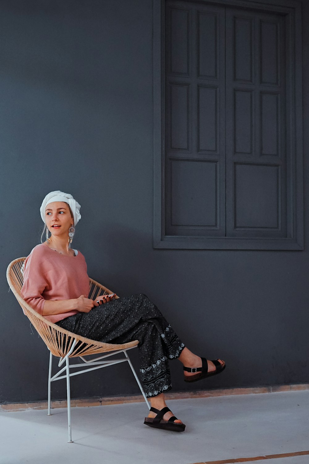 woman sitting on chair near window