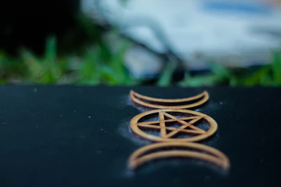 Close-up of the pentacle in the Page's hands, highlighting intricate gold patterns and symbols.