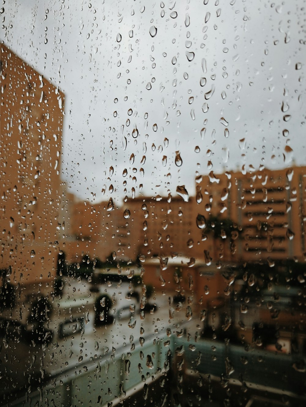 selective focus photography of water drops at glass window