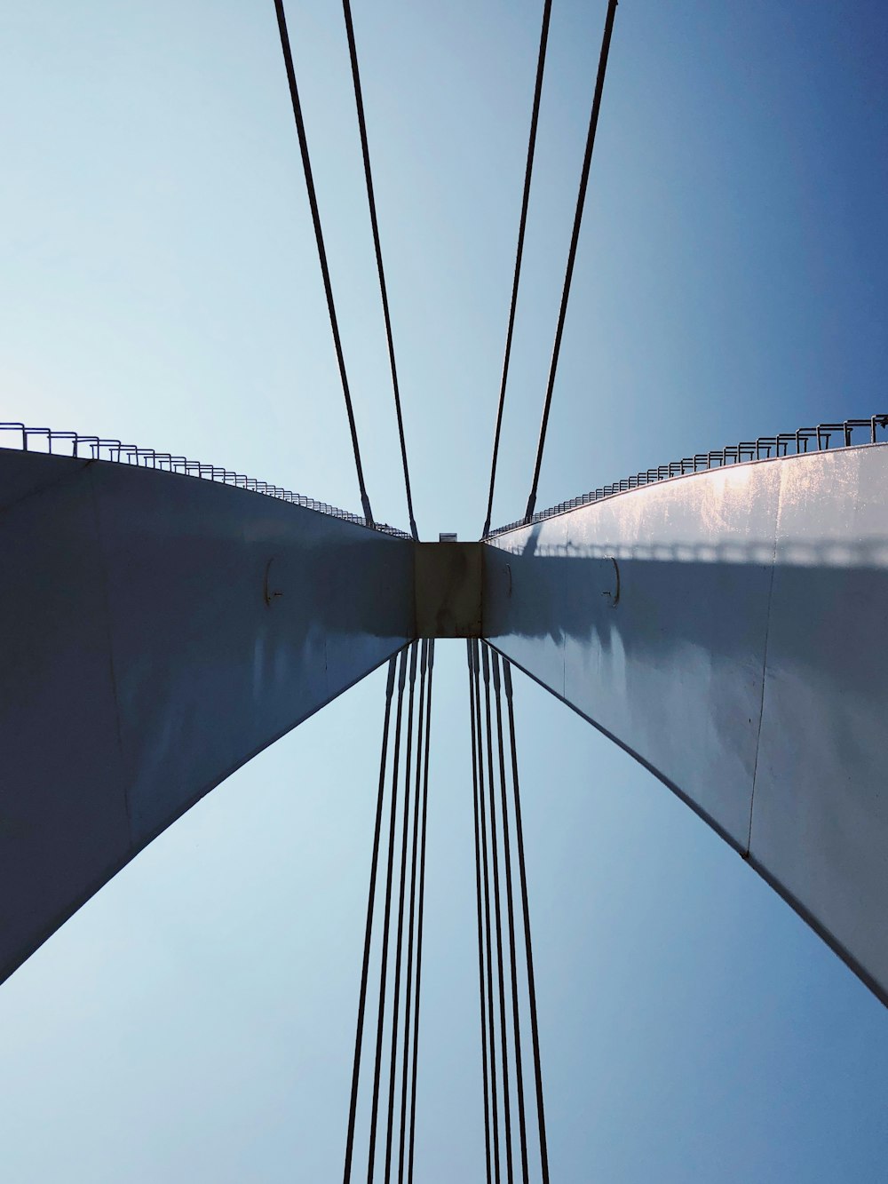 a view of the top of a bridge from below