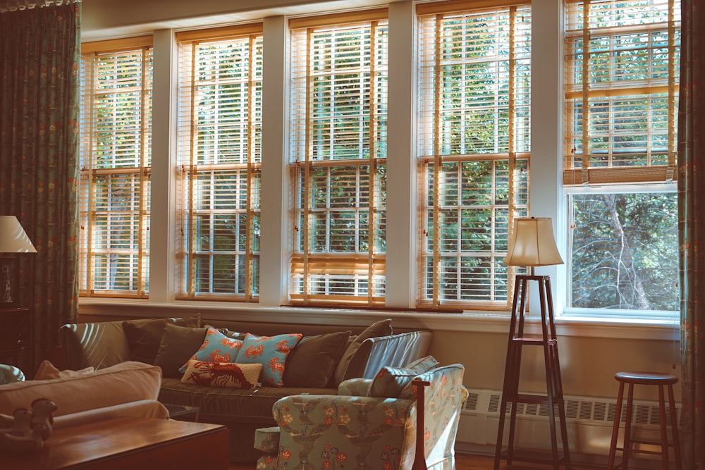 a living room filled with furniture and lots of windows