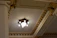 Close-up of a luxurious false ceiling with gold accents and soft ambient lighting.