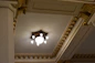 Close-up of a luxurious false ceiling with gold accents and soft ambient lighting.