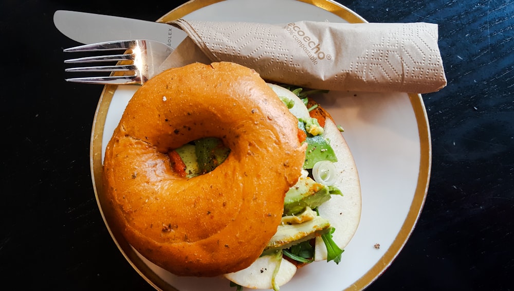 brown burger on round white and brown ceramic plate