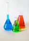 three assorted-color liquid-filled laboratory apparatuses