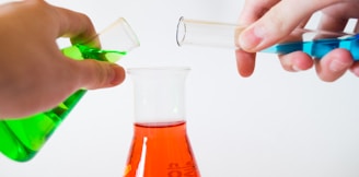 person holding laboratory flasks