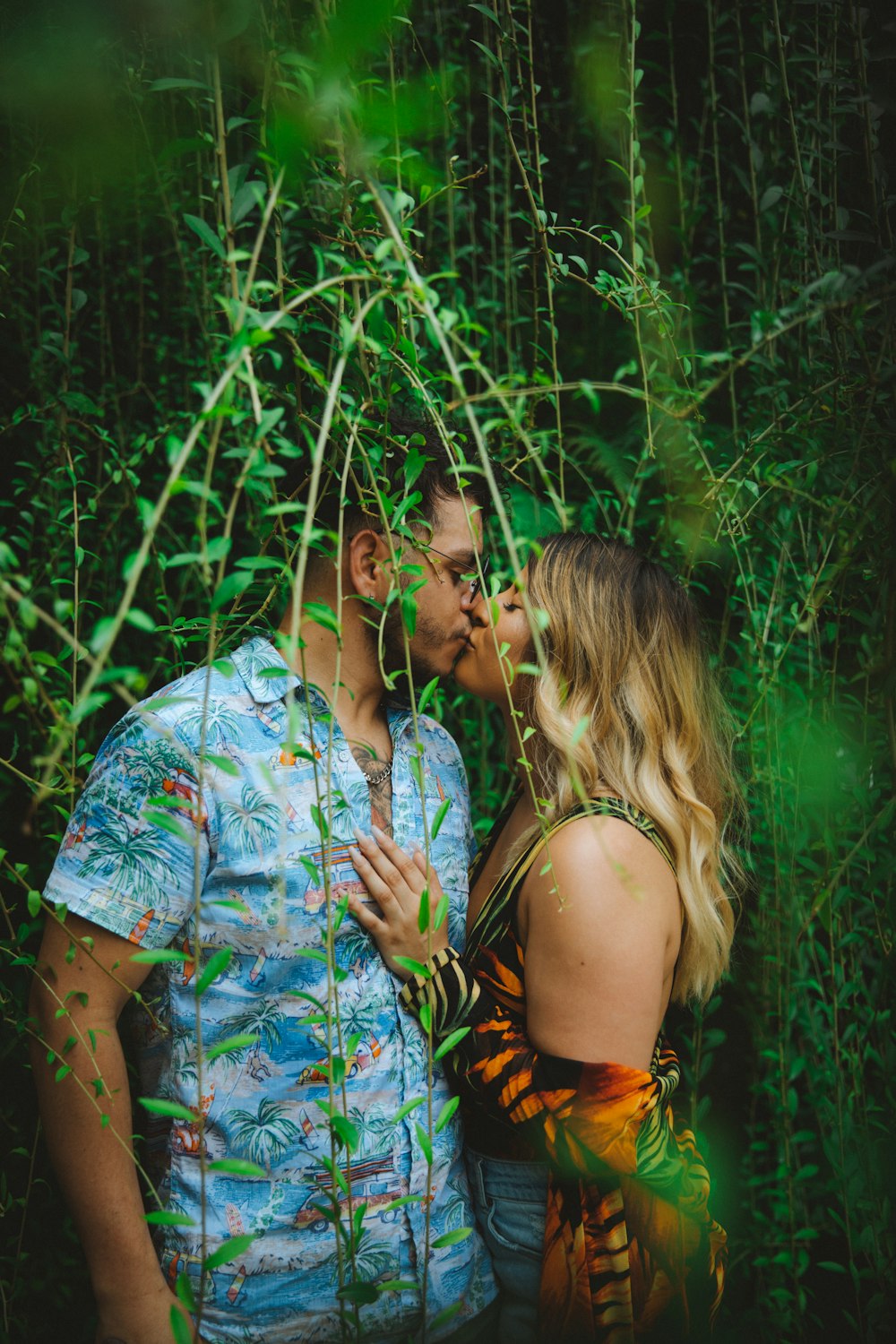 man and woman sitting under tree