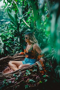 woman sitting on brown tree roots