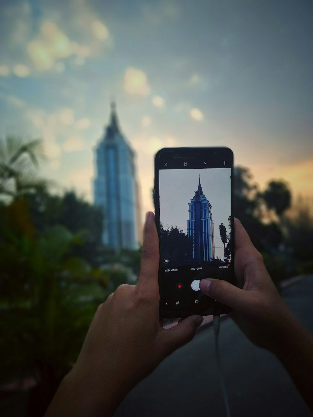 person taking photo of building