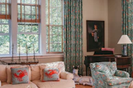 An airy, sunlit living room featuring tasteful nautical decor and comfortable seating.