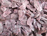 Vibrant close-up of freeze-dried fruit pieces glowing with neon purple and pink hues
