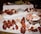 Corporate guests gathered around a beautifully arranged raw bar with lobster rolls and fresh seafood.