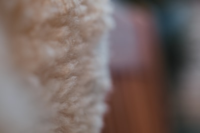 Close-up of a soft, hand-knit wool sweater in warm earth tones.