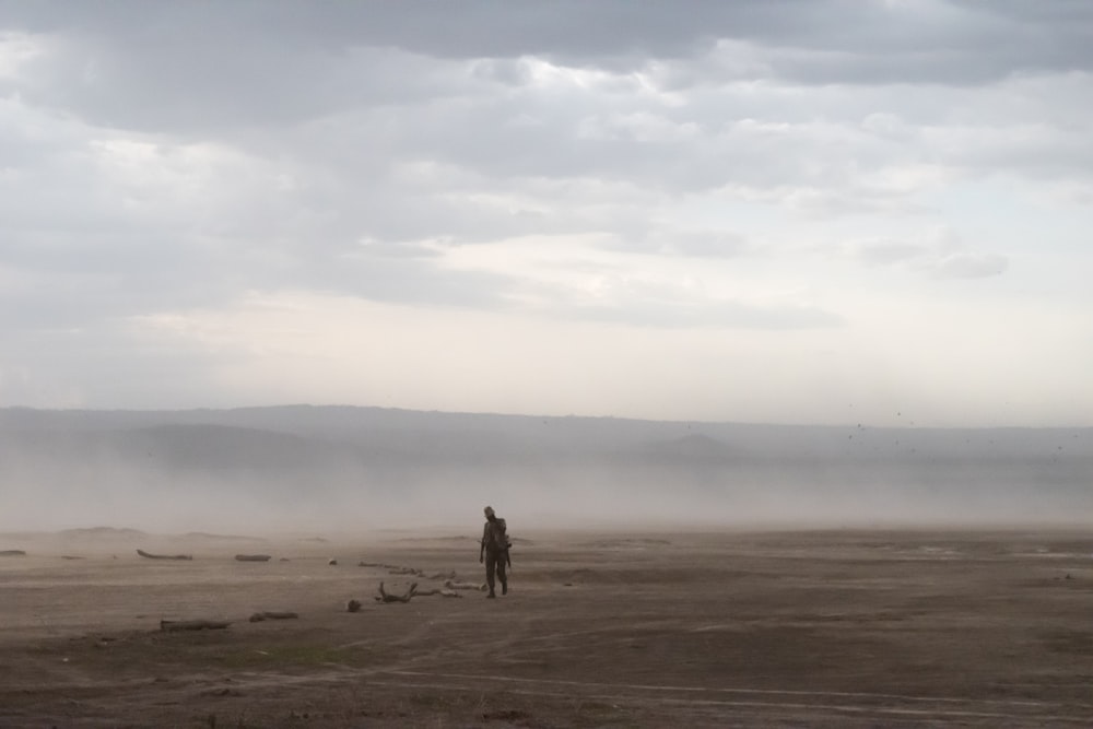 1 person walking in the middle of the desert