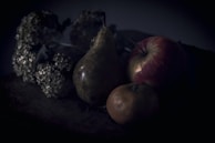 An elegant still life arrangement of fruits on a wooden table.