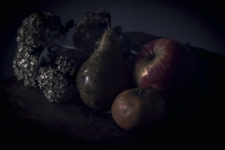 An elegant still life arrangement of fruits on a wooden table.
