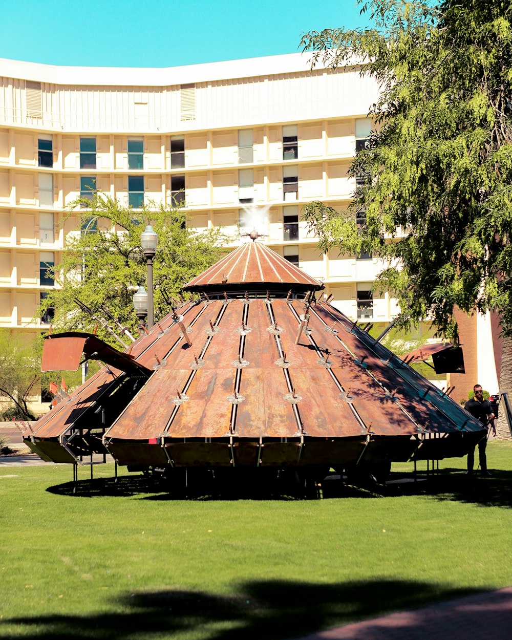 man standing near brown building