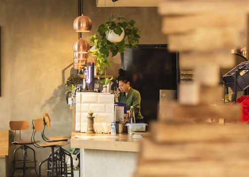 A small business owner serving customers in a cozy shop.