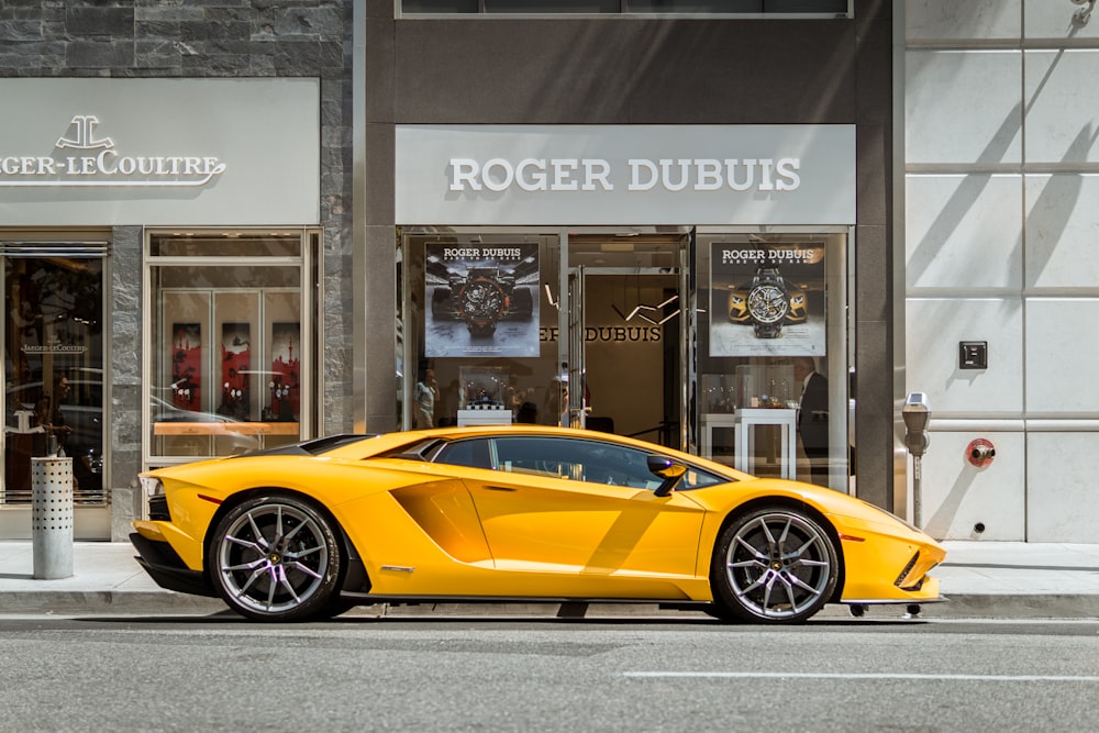 yellow Lamborghini coupe parked outside storefront