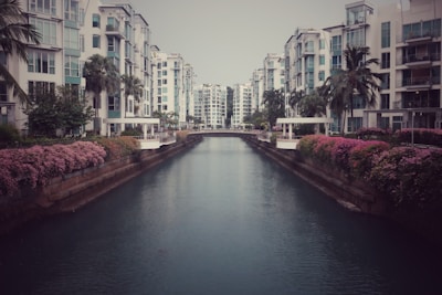 Modern luxury condo balcony overlooking calm canals and vibrant sunset hues.