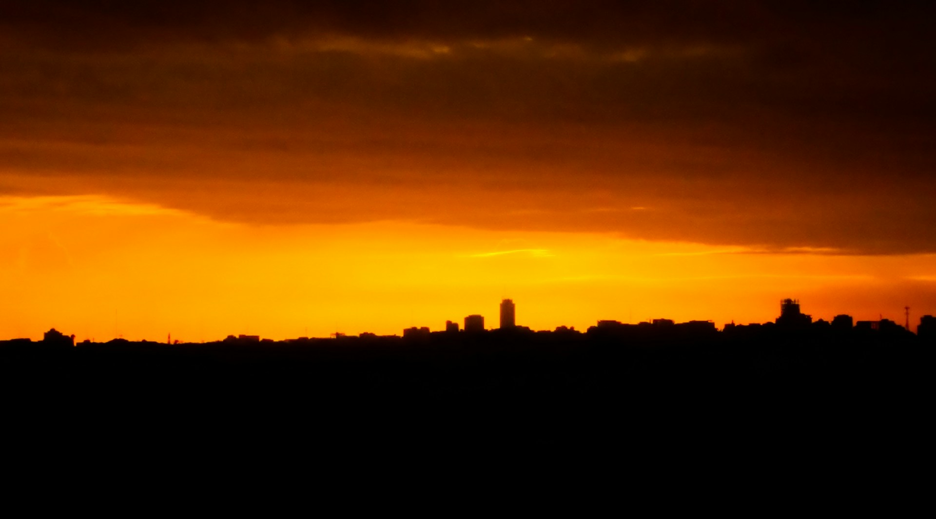 woman wearing yellow long-sleeved dress under white clouds and blue sky during daytime