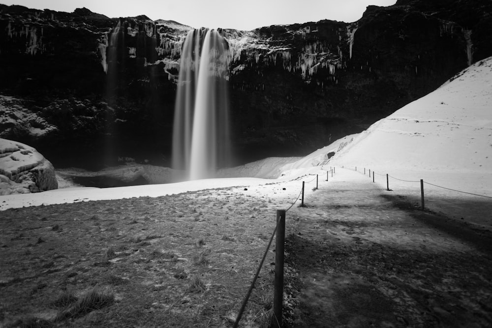 view of waterfalls in grayscale photo