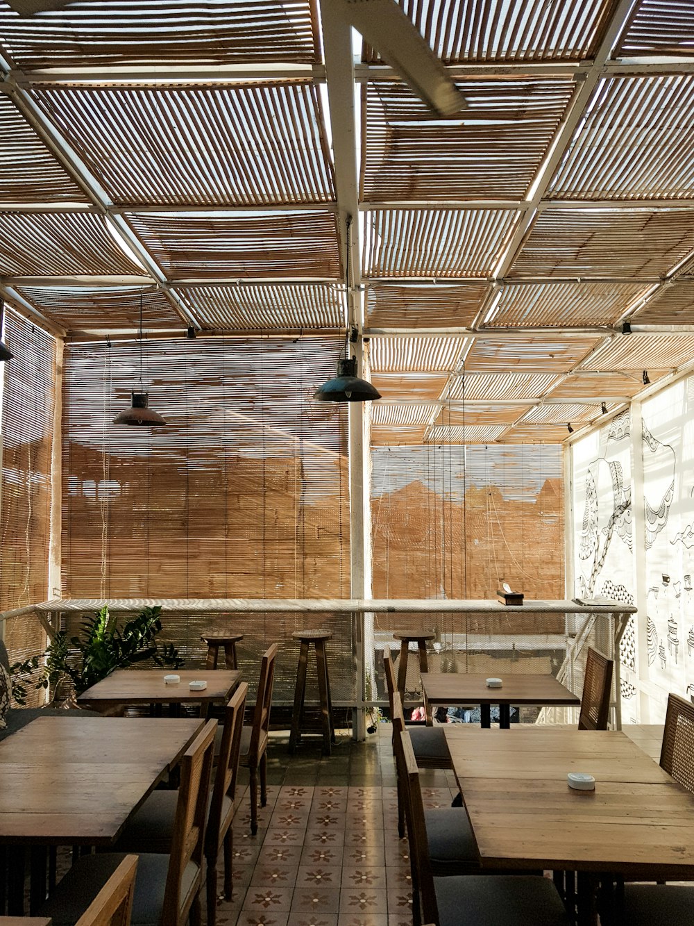 four vacant wooden tables in room