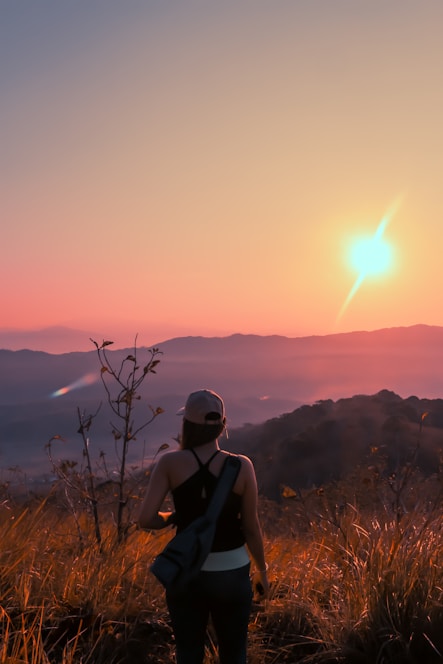 A smiling companion and traveler enjoying a scenic mountain view in Himachal Pradesh at sunset