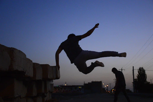 Player leaping over rooftops in vibrant cityscape from Jesus Run game developed by Tizon Games.