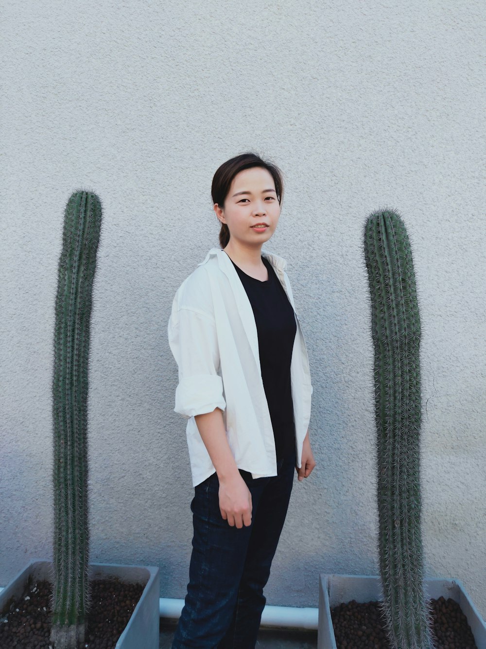 woman standing between cacti