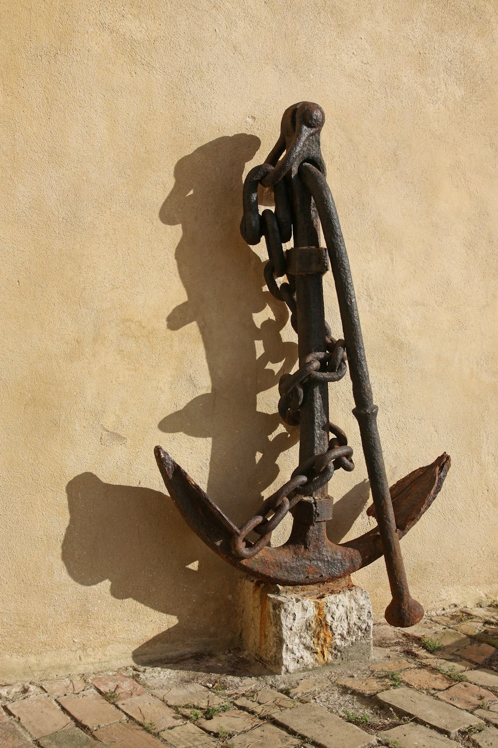 brass anchor near beige wall