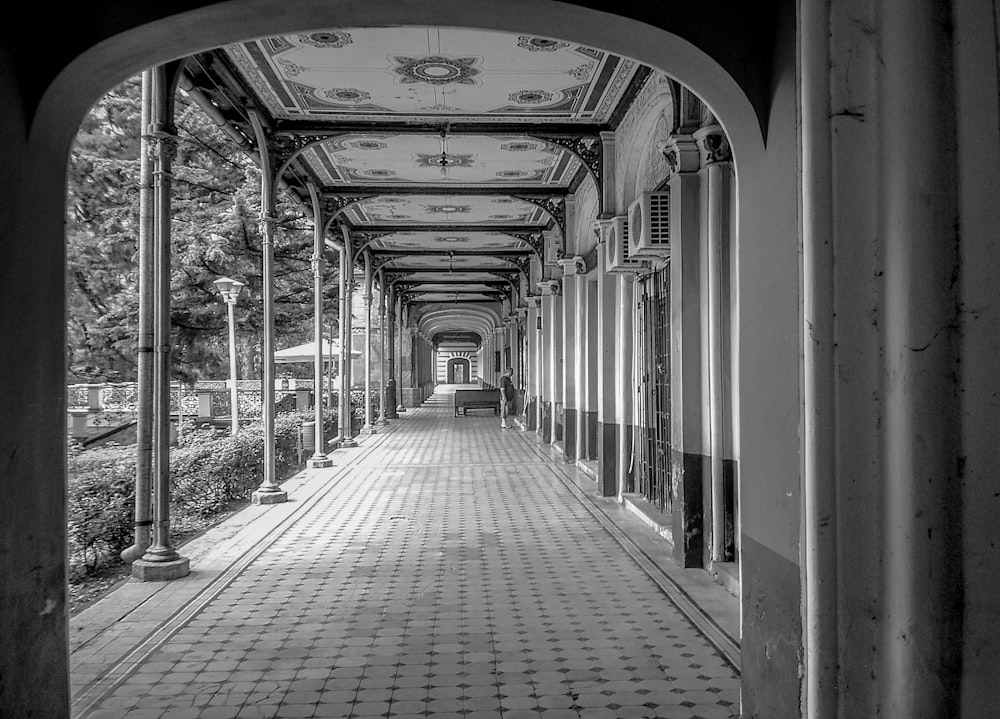 grayscale photo of arch hallway