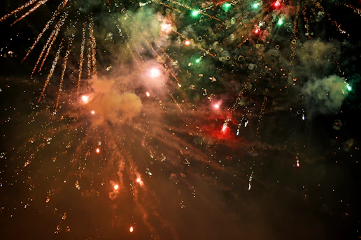 A vibrant fireworks display lighting up the night sky over a festive event.