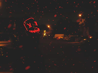 Spider-Man mask illuminated by red LED lights, emphasizing its futuristic style.