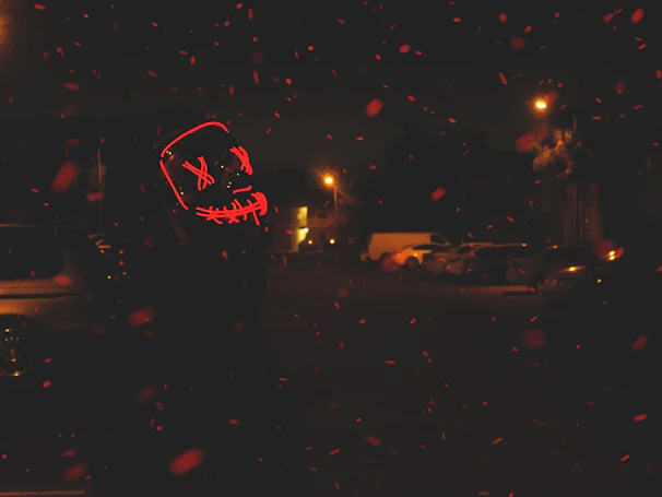 Spider-Man mask illuminated by red LED lights, emphasizing its futuristic style.