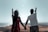 A happy couple exploring a scenic destination with a beautiful landscape in the background.