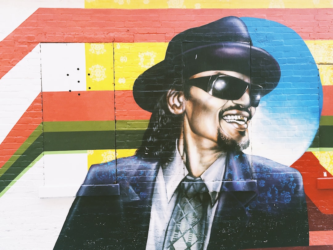 man wearing hat graffiti on wall