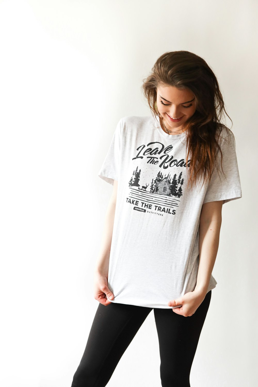 smiling woman in black and white print t-shirt