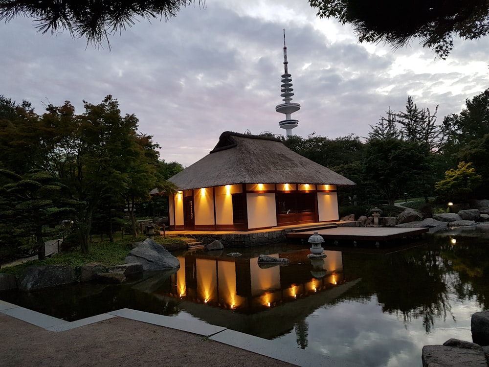 white and brown house surrounded with body of water