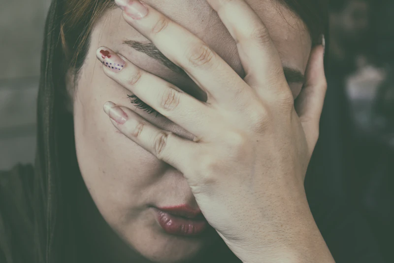 Woman with her hand on her face in sinus pain