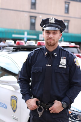 policeman standing in front of police car